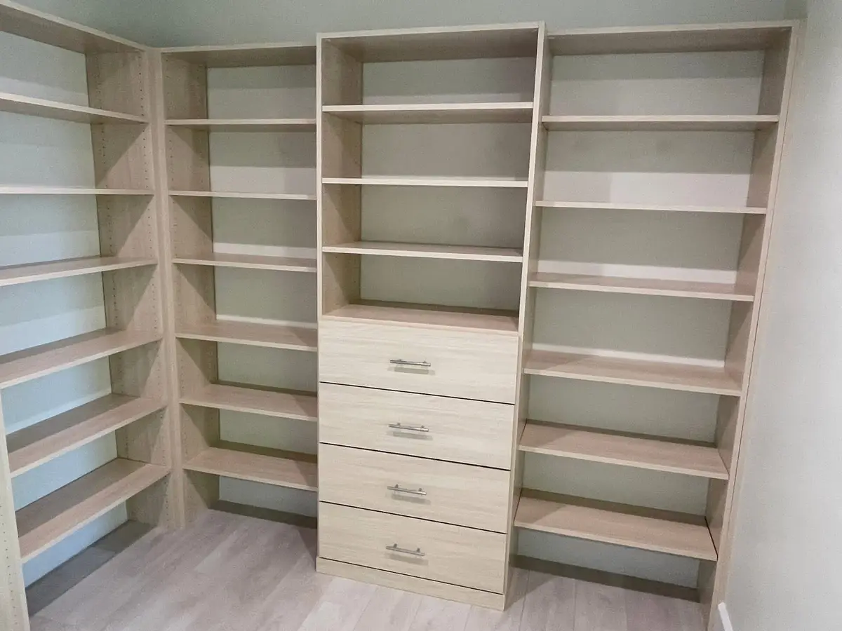 Custom walk-in closet with light-wood built-in shelving installed by C&C Multiservices in Connecticut